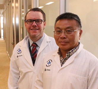 two people in lab coats standing in a hallway