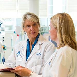 two people in white lab coats