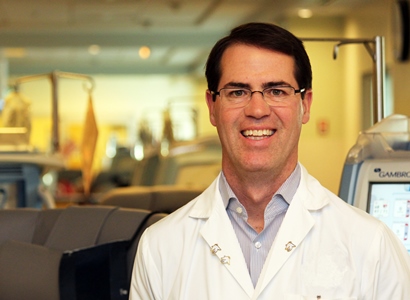 a person in a lab coat and glasses