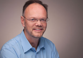 a person in a blue shirt and glasses