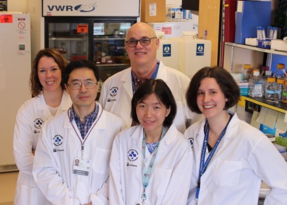 a group of people standing in a lab