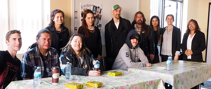 a group of people standing around a table