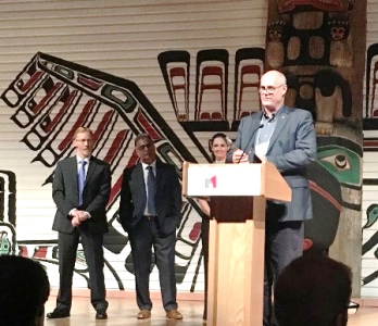 a person standing at a podium in front of a crowd