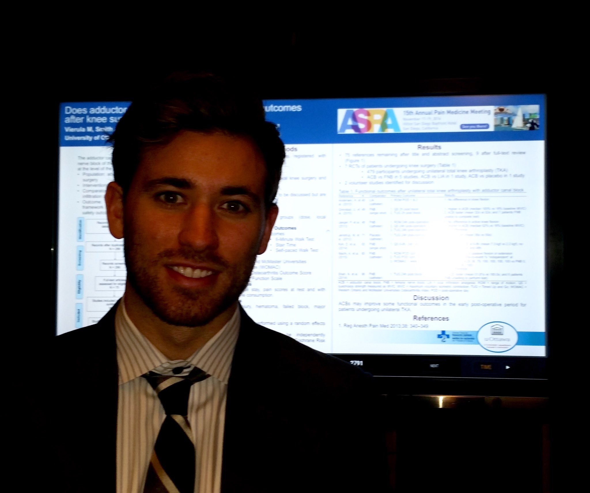 Person standing beside a poster