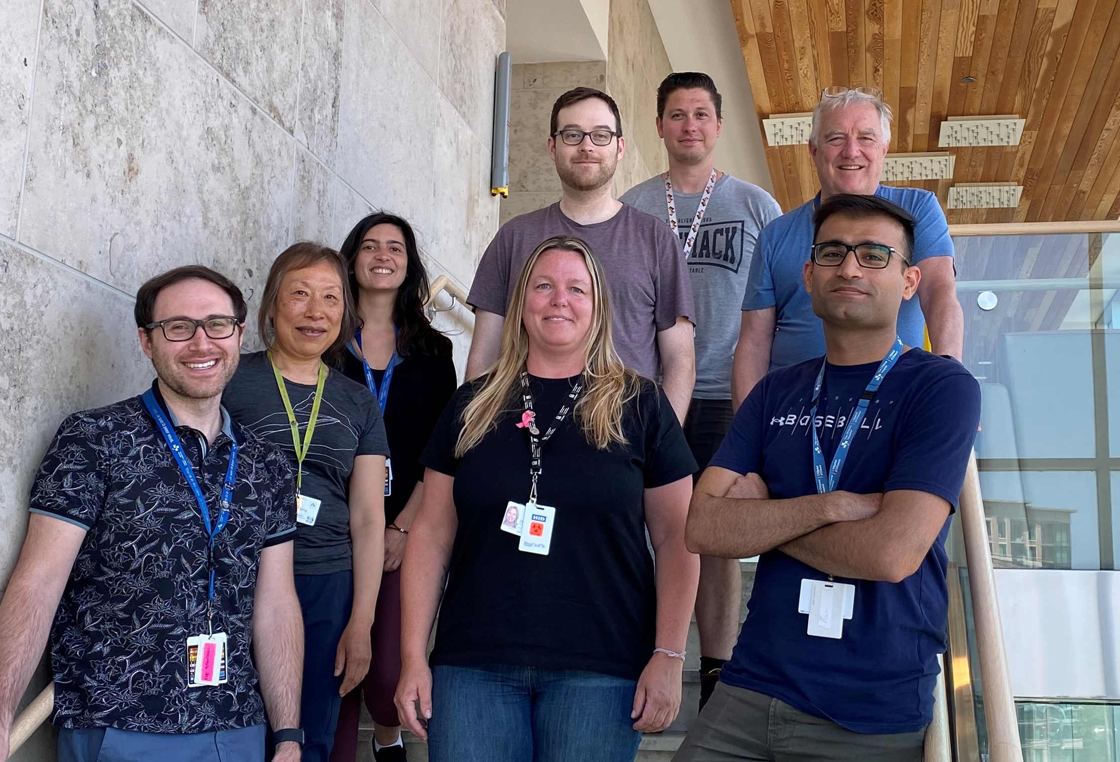 Members of Dr. John Bell's team standing on a staircase.