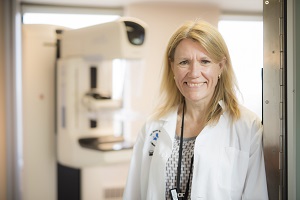 Woman in lab coat standing in clinic