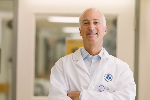 A doctor stands in a hospital hallway