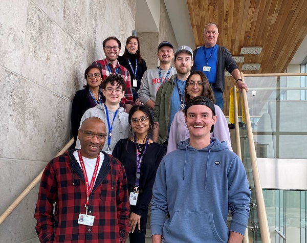 Researchers stand on a staircase