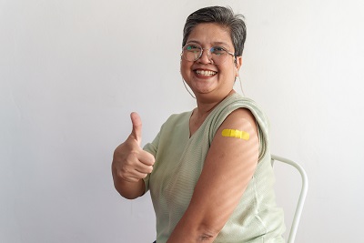 Person giving a thumbs up after getting a vaccine