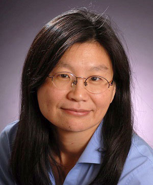 a person with glasses and a blue shirt