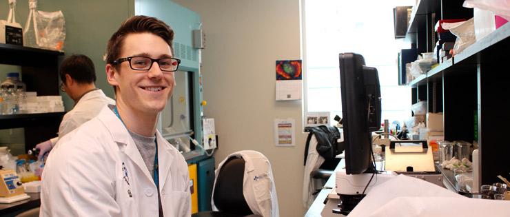 a person in a lab coat sitting at a computer
