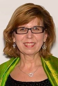 a person in a green jacket and glasses