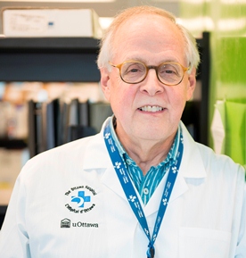 a person in a lab coat and glasses