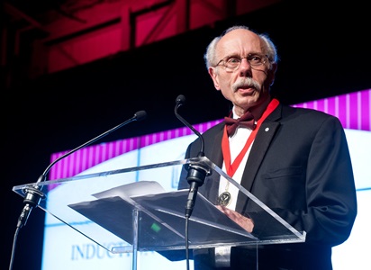 a person standing at a podium with a microphone