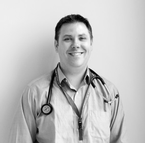 a person in a doctor's uniform standing next to a wall