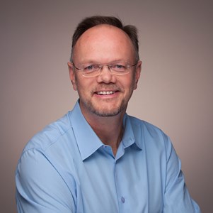 a person in a blue shirt and glasses