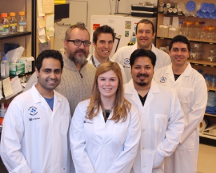 a group of people standing in a lab