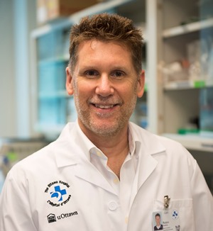 a person in a lab coat standing in front of a counter