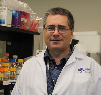 a person in a lab coat standing in front of a shelf