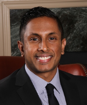 a person in a suit sitting in a chair