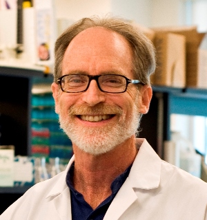 a person in a lab coat and glasses