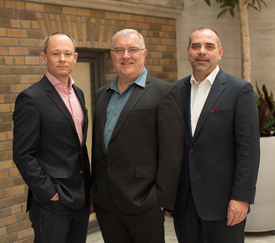 three people standing next to each other