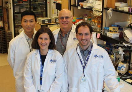a group of people standing in a lab