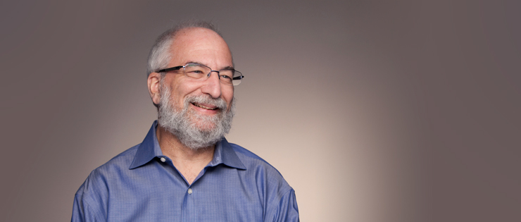 a person with glasses and a blue shirt