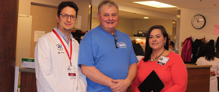 three people standing in a room