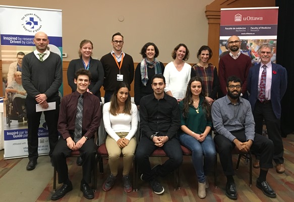 a group of people sitting on chairs in front of a banner