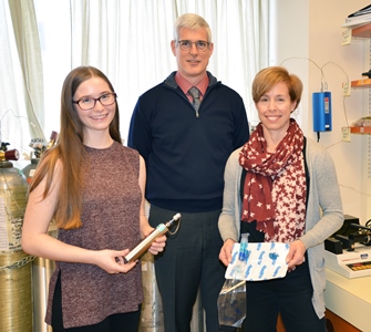 three people standing in a room
